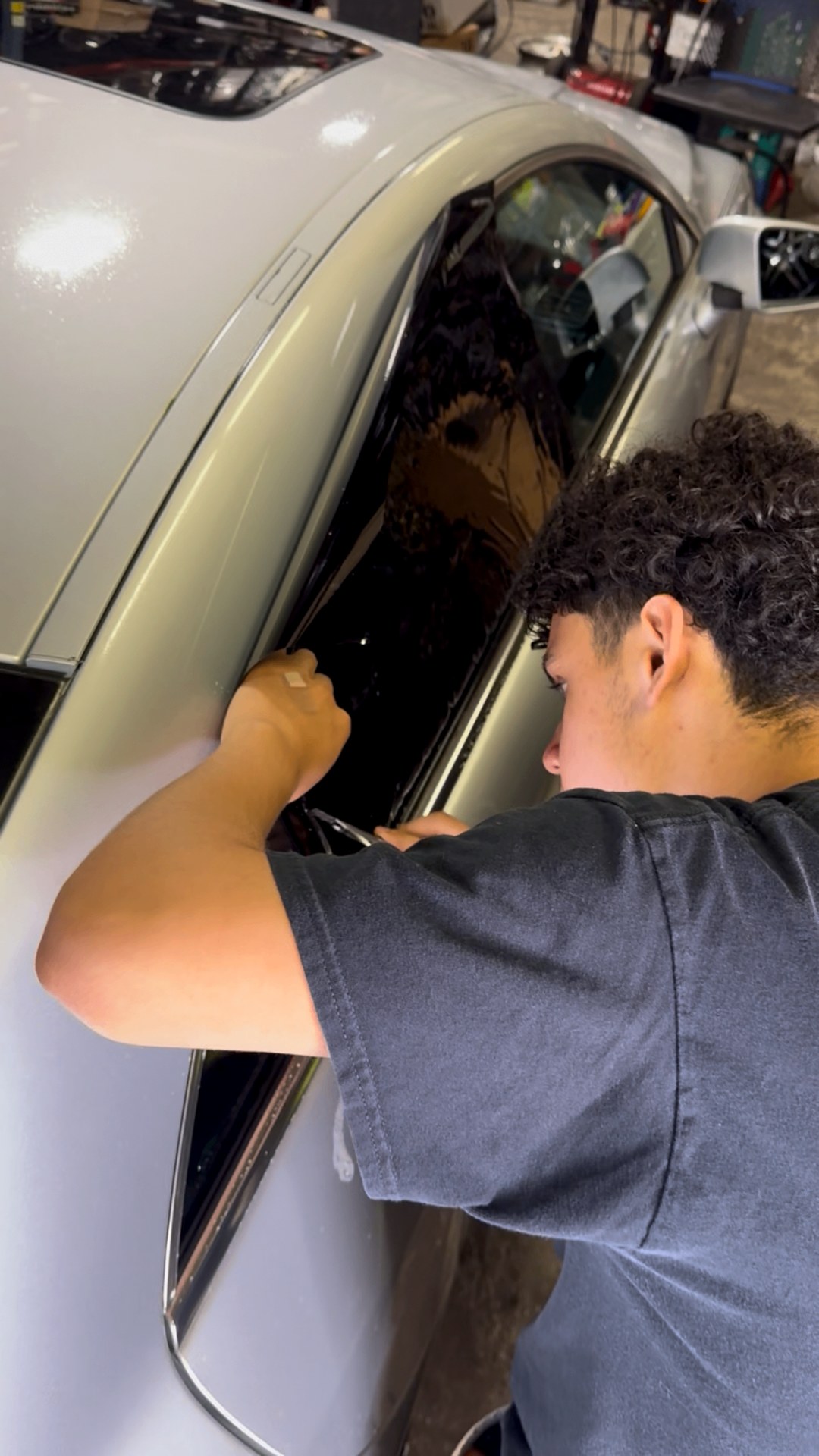 Silver sedan tint install: Edges trimmed and finished